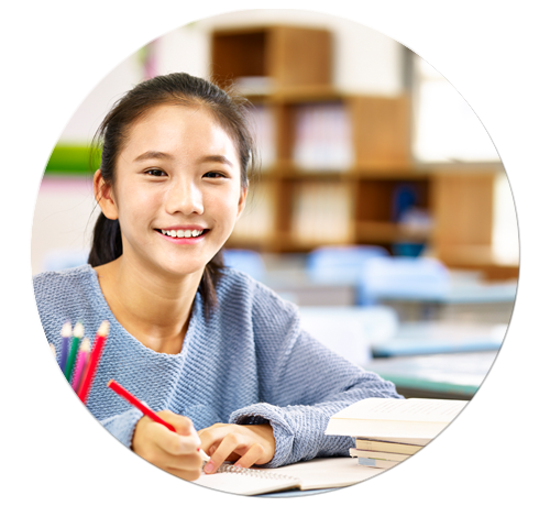Girl happily working on math worksheets